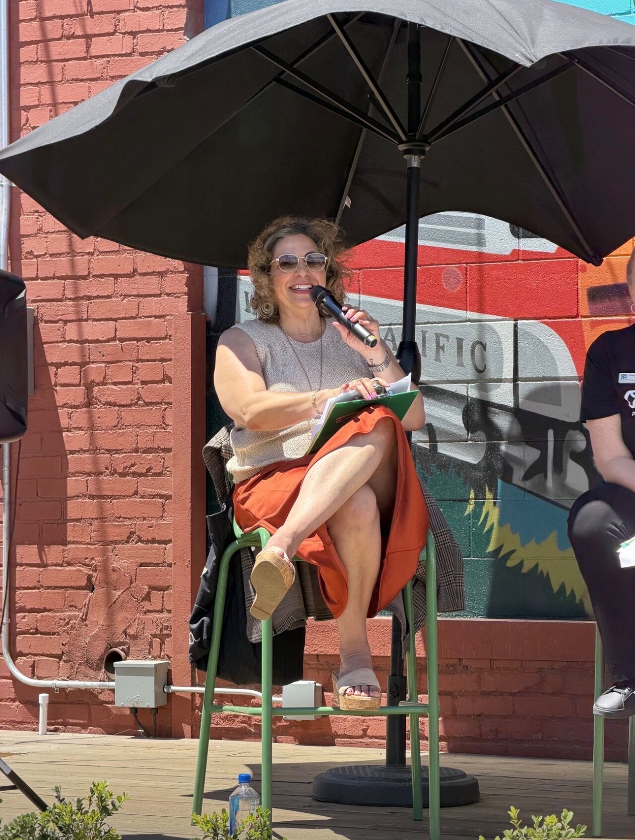 Kim Bardakian moderating an outdoor community panel