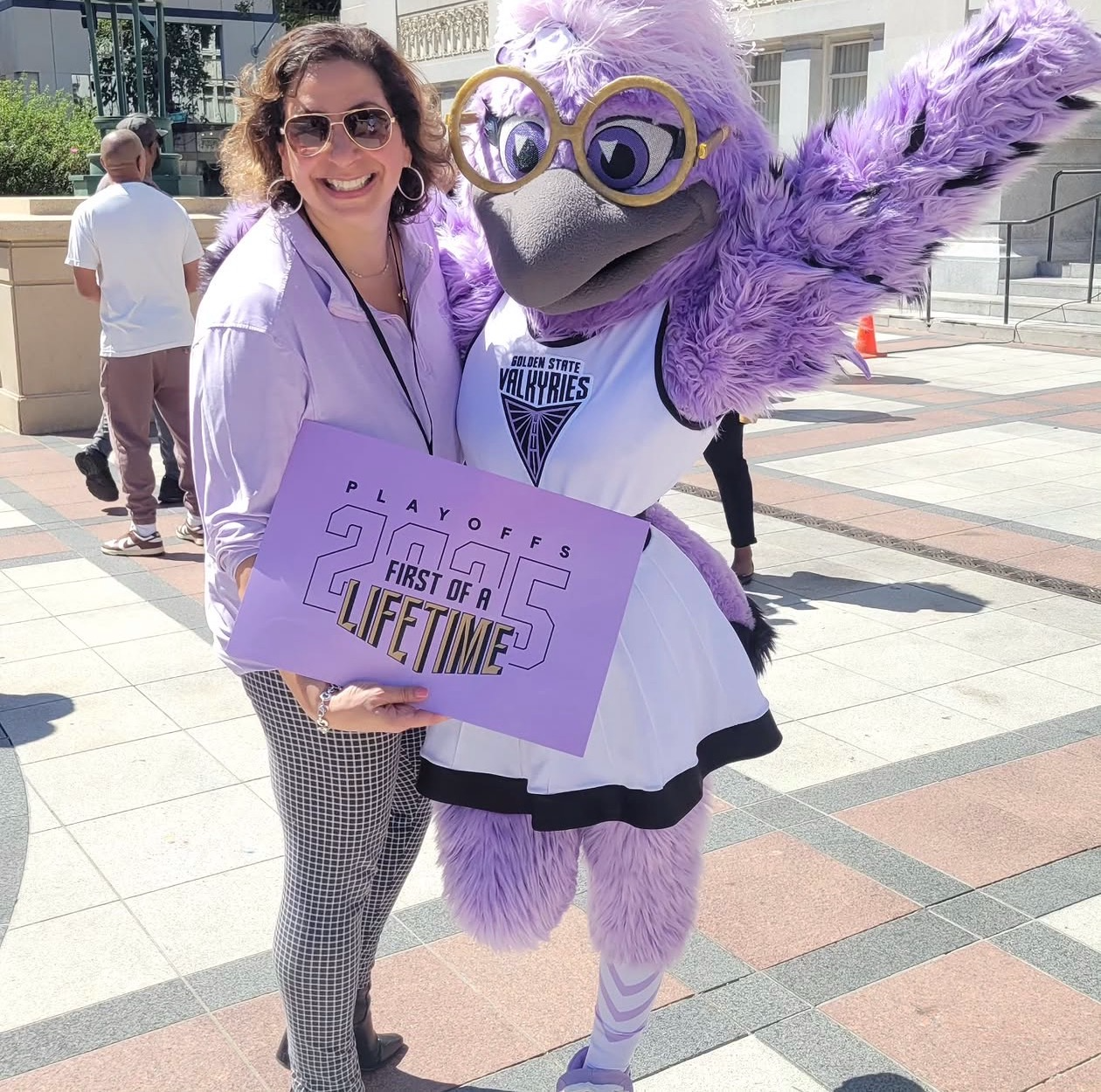 Kim Bardakian with the Golden State Valkyries mascot at a playoff rally